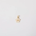 Detail of flower charm with white enamel and gold finish on high-quality stainless steel - Flower