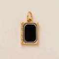 Macro shot of gold book charm featuring a black enamel center and ribbed spine detail - Book Tablet Shape (No. 15 Tablet)