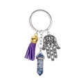 Close-up of Hamsa hand pendant with blue crystal pillar and purple fringe tassel charm - Blue Spot Jasper