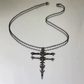 Dark gothic skeleton cross necklace with a matte black finish and vintage spine design - Skeleton Cross Necklace / Black