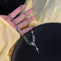 Close-up of asymmetrical silver chain with moonstone beads and star pendant on skin - Asymmetric Moonstone Cross Style / Silver