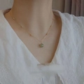 Elegant 18K gold chain necklace featuring a polished green Hetian jade bead pendant - Gold