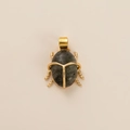 Detailed view of a golden beetle pendant featuring a natural grey oval gemstone inlay - Dark Gray Stone Beetle Style