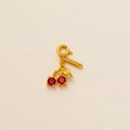 Exquisite gold cherry charm with red gemstones and a small leaf and branded tag - Cherry with Tag