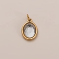 Oval gold pendant with clear faceted zircon inlay in classic bezel setting - April Birthstone Pendant