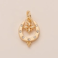 Macro view of golden horseshoe pendant featuring a central star and seven zircon stones - Horseshoe Pendant