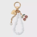 Detailed shot of gold cherry keychain with pearls, shells, and sparkling rhinestones - Rhinestone Cherry (Artificial Pearl) / Cherry Pearl Charm