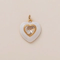 Macro detail of white enamel heart pendant with a centered zircon in 18K gold frame - White Heart Style