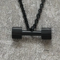 Macro shot of black dumbbell pendant necklace showing the polished metal texture - Black (Pendant Only (Without Chain))