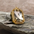 Macro shot of gold square pendant with large faceted zircon on natural stone backdrop - Pendant Only (Without Chain) / Gold Champagne (HT-4146)