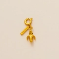Detail view of a gold banana pendant with gentleness engraving and crystal accents - Banana