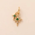 Golden sunburst star pendant necklace with green crystal inlay and white diamond accents - Starburst Pendant