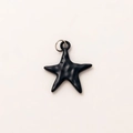 Detailed macro view of a matte black starfish pendant with textured resin finish - Black Star Pendant