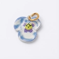 Close-up of a blue ceramic pansy pendant with a face design and gold plated ring - Clover Pendant