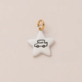 Close-up of star shaped white charm with car illustration and gold plated metal ring - White Star Car Pendant