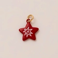 Macro shot of a red star pendant with white rays and a golden metal ring for DIY jewelry - Red Star Firework Pendant