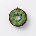 Detailed top view of a realistic kiwi fruit slice pendant with golden metal loop - Kiwi Fruit Pendant