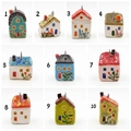 Detailed macro view of ten colorful hand-painted ceramic house pendants with metal loops - 1 Grey Roof