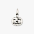 Macro detail of a vintage titanium pumpkin charm with oxidized Jack-o'-lantern features - Pumpkin Head