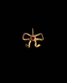 Golden bow pendant with a red heart-shaped gemstone center on a dark background - Gold Bowknot Pendant