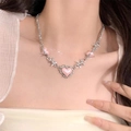 Y2K pink heart necklace with silver thorn chain for women shown on model neck - Necklace