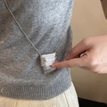 Mini silver woven texture handbag pendant necklace with delicate snake chain on model - Crossbody Bag Necklace