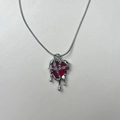 Macro shot of punk style molten lava heart pendant with red resin and silver chain - Necklace / Molten Lava Heart Necklace (Red)