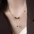 Vintage gold layered necklace with tiger eye beads and sun pendant on female model - Tiger Eye Double Layer Necklace (Beaded)