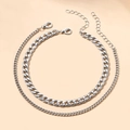 Detail of layered silver alloy anklets featuring a bold Cuban link and slim curb chain - Double Layer Cuban Chain / Silver