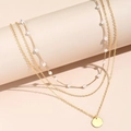 Detailed view of layered gold-plated necklaces with pearls and a polished round pendant - Gold Three-Layer Pearl Round Pendant Necklace (XL1080-5)