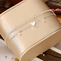 Detail of silver double-layer bracelet with heart pendant and zircon charms on jewelry box - Silver Double Layer Heart Zirconia (SH141-9)