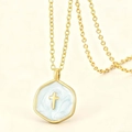 Golden necklace with blue enamel hexagonal cross pendant on elegant beige background - Blue Cross Necklace