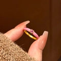 Detail of pink heart gemstone ring with gold band and enamel finish on hand - Pink Heart (JZ257)