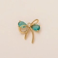 Elegant 18K gold-plated bow charm with drop-shaped blue gemstones and micro-diamonds - Blue Bow Pendant