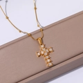 Macro shot of 18k gold plated heart-shaped crystal cross pendant on elegant beaded chain - Heart Shape Zirconia Cross Style (JJN0295)