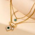 Detail of layered gold titanium necklace with emerald and turquoise charms - Gold Square Green Crystal Necklace
