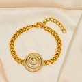 Macro view of gold chain bracelet with triple concentric circles and white crystal details - Circle Bracelet 1