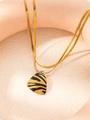 Detailed close-up of golden snake chain with a zebra-patterned triangle pendant - Triangle Zebra Print Necklace