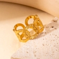 Macro detail of gold-plated stainless steel ring with overlapping C-shaped patterns - Hollow Chain Texture Style (BJGR0263)