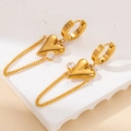 Detailed close-up of golden heart drop earrings with zircon stones and link chains - Gold 3D Heart