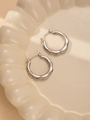 Macro detail of silver titanium steel hoop earrings with textured spiral design - Spiral Twisted Style (#0236)