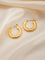 Macro view of gold hoop earrings with textured hexagonal honeycomb pattern on silk - Round E0254 Style