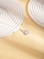 Detailed macro view of silver steel necklace with tiered pearl pendant on stone base - Necklace (N0190)