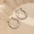Detailed macro view of silver hoop earrings with unique geometric X-shaped textures - X-Cross Decorative Texture Style (BJGE0234) / Silver