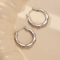 Close-up of silver retro geometric hoop earrings with textured wavy surface patterns - Wavy Thick Twisted Style (BJGE0236) / Silver