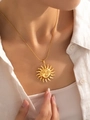 Macro shot of gold sun goddess face pendant on elegant titanium steel chain necklace - Sun God Pendant Necklace
