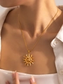 Elegant gold sun totem necklace with hammered texture shown on model neck for luxury style - Hammered Sun Totem