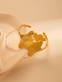Detail view of 18K gold-plated open bangle featuring textured overlapping ginkgo leaves - Overlapping Ginkgo Leaf Style