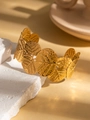 Macro detail of leaf-shaped gold titanium steel bracelet with elegant hammered texture - Hammered Broad Leaf Vein Style