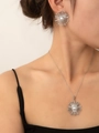 Close-up of silver sunflower jewelry set with white pearls worn by a model - Jewelry Set (S0075)